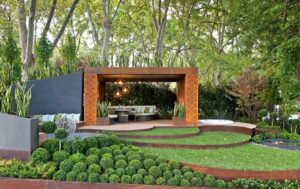 Modern outdoor living pavilion with Corten steel frame and concrete planters in Melbourne show garden