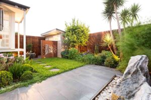 Timber pergola with laser-cut corten steel screens and structured planting in Hawthorn East courtyard garden