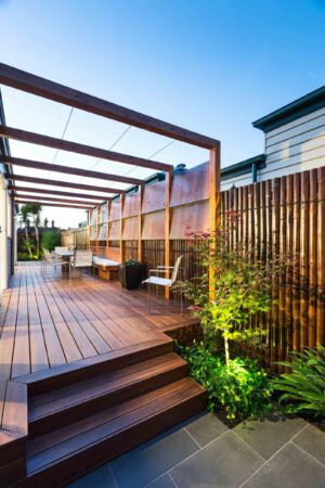 Timber pergola over decked courtyard with Corten steel screens and bamboo fencing in Hawthorn East Melbourne garden