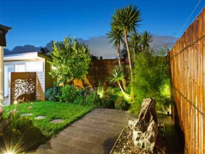 Timber pergola and Corten steel screens create privacy in compact Hawthorn East courtyard garden with integrated lighting