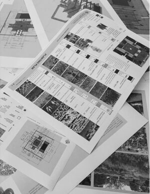 Black and white photograph showing scattered design plans, material samples and construction documentation for the award-winning Mandala Moon Gate Garden at Nagasaki Gardening World Cup