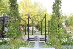 Circular black steel moon gate frames water feature with sculptural sphere in award-winning Mandala Garden, Nagasaki