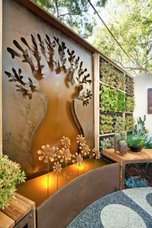 Sculptural corten steel tree wall with cut-out branches and integrated lighting at Melbourne International Flower Show