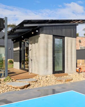 Modern house with 3D printed concrete walls, corrugated metal roof with solar panels, and swimming pool at Daylesford