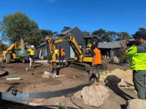 Construction crew with excavator working on landscape earthworks at The Block Daylesford House 5 project site