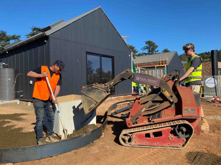 Construction workers operating skid steer loader on earthworks at The Block Daylesford House 5 landscape project site