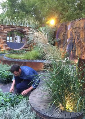 Landscape designer working on curved timber decking installation in award-winning Wattlebird Garden, Nagasaki Japan