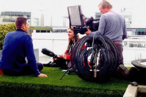 Television crew filming interview on rooftop garden location for award-winning Wattlebird Garden project in Nagasaki