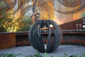 Black perforated metal spherical water feature in award-winning Garden of the Little Wattlebird, Nagasaki Japan