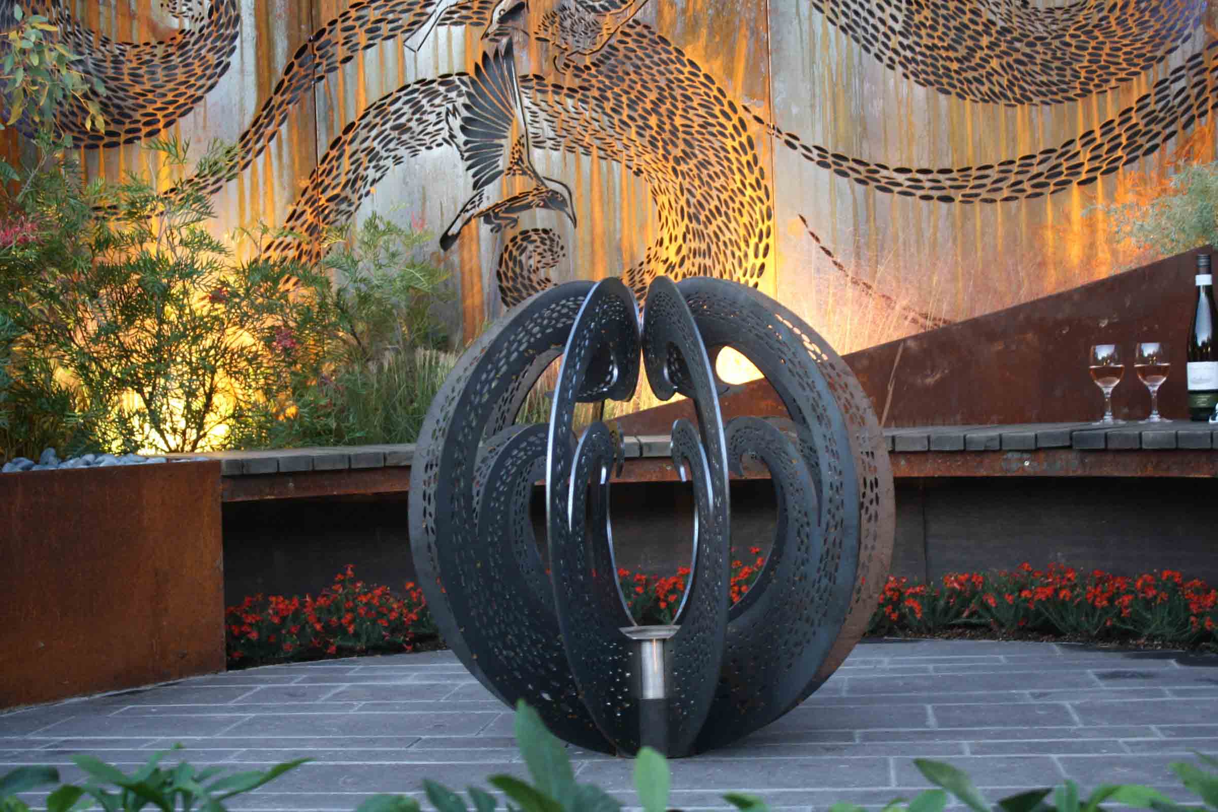 Black perforated metal spherical water feature in award-winning Garden of the Little Wattlebird, Nagasaki Japan