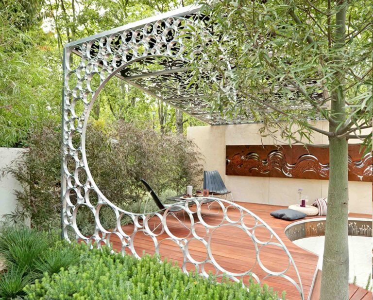 Circular steel garden structure with organic perforations framing pathway in modern landscape design