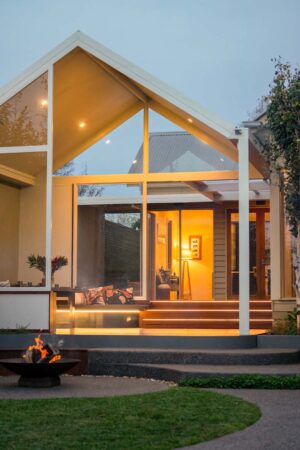 Modern outdoor living space with curved corten seating around fire pit and timber deck pavilion at Armstrong Street Ballarat