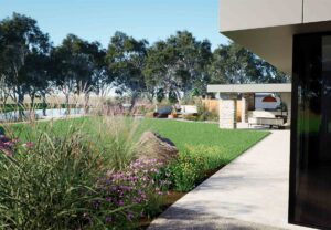 Curved concrete pathway through native plantings with outdoor kitchen pavilion in background at Mount Sturgeon Dunkeld