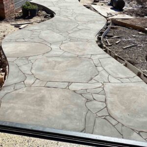 Curved stamped concrete pool deck with flagstone pattern during construction at Mount Buninyong country estate