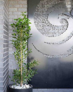 Covered outdoor seating area with corten steel feature screen and compact backyard design
