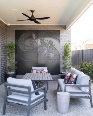 Corten steel wattle bird screen with outdoor seating area in small contemporary backyard design