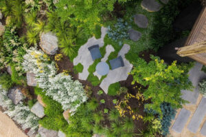 Aerial view of contemporary garden with circular pool, curved paths, native plantings and outdoor entertaining areas